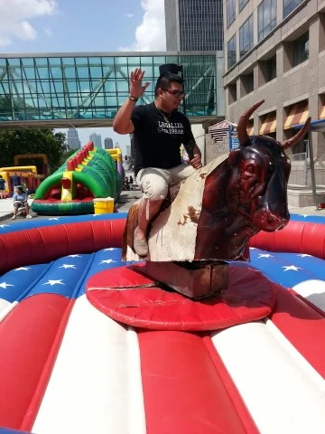 Adult riding mechanical bull at downtown Kansas City event