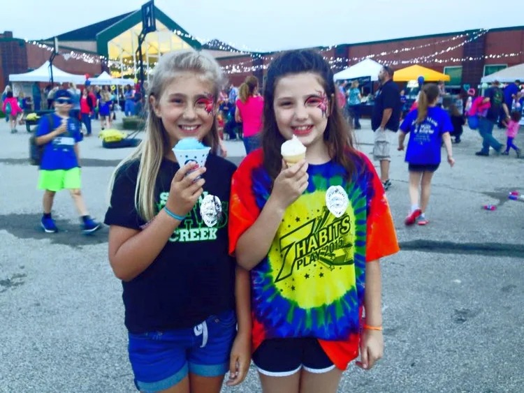 Kids with snow cone and ice cream at festival concessions