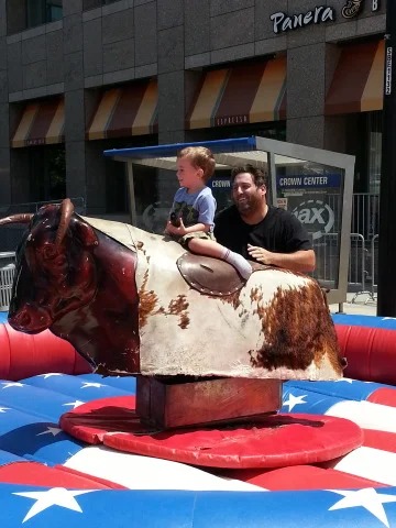 Child riding mechanical bull at Crown Center event